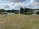 Community pool and pond surrounded by lush greenery in a well-maintained community at 1301 S Hercules Ave # 19, Clearwater, FL 33764