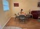 Dining room with a set table and seating for four near a bright red sofa at 1301 S Hercules Ave # 19, Clearwater, FL 33764