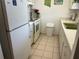 Functional kitchen with white appliances, cabinetry and tile flooring at 1301 S Hercules Ave # 19, Clearwater, FL 33764