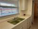 Kitchen sink and countertops offer a view through the window at 1301 S Hercules Ave # 19, Clearwater, FL 33764