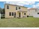 View of the two story home, patio, and backyard at 13506 Copper Belly Ct, Riverview, FL 33569