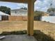 Backyard view showing the fence lines and the home's exterior, ready for landscaping at 13506 Copper Belly Ct, Riverview, FL 33569