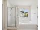 Bright bathroom with shower and separate tub under a window at 13506 Copper Belly Ct, Riverview, FL 33569