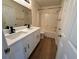 Bathroom featuring double sink vanity with white cabinets, quartz countertop, and tiled shower at 13506 Copper Belly Ct, Riverview, FL 33569