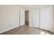 Cozy bedroom with wood floors, closet, and neutral walls at 13506 Copper Belly Ct, Riverview, FL 33569