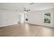 Spacious bedroom with wood-look flooring, ceiling fan, and two windows at 13506 Copper Belly Ct, Riverview, FL 33569