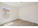 Bright bedroom with wood floors and a large window at 13506 Copper Belly Ct, Riverview, FL 33569