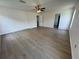 Spacious bedroom featuring wood-look floors and a ceiling fan for added comfort at 13506 Copper Belly Ct, Riverview, FL 33569