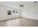 Spacious bedroom with light wood floors, a ceiling fan, and abundant natural light at 13506 Copper Belly Ct, Riverview, FL 33569