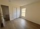Bedroom featuring wood flooring, a closet, and natural light from a window at 13506 Copper Belly Ct, Riverview, FL 33569