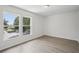 Bright bedroom featuring two large windows offering ample natural light at 13506 Copper Belly Ct, Riverview, FL 33569