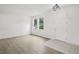 Inviting entryway features wood floors, two windows, and modern lighting fixture at 13506 Copper Belly Ct, Riverview, FL 33569