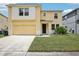 Charming two-story home featuring a well-maintained lawn and inviting entryway at 13506 Copper Belly Ct, Riverview, FL 33569