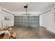 Spacious garage with a large sectional door and open ceiling at 13506 Copper Belly Ct, Riverview, FL 33569