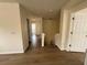 A clean, bright hallway with wood floors that leads to multiple rooms and a staircase at 13506 Copper Belly Ct, Riverview, FL 33569
