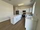 Bright kitchen with white cabinets, stainless steel appliances, and a large island with a white countertop at 13506 Copper Belly Ct, Riverview, FL 33569