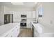 Bright kitchen featuring white cabinets, stainless steel appliances and an island at 13506 Copper Belly Ct, Riverview, FL 33569