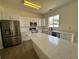 Kitchen boasting stainless appliances, quartz countertops, and a spacious island for cooking at 13506 Copper Belly Ct, Riverview, FL 33569