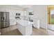 Bright kitchen features white cabinets, quartz countertops, island, and stainless steel appliances at 13506 Copper Belly Ct, Riverview, FL 33569