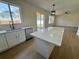 Open kitchen concept featuring quartz countertops, island seating, and modern stainless appliances at 13506 Copper Belly Ct, Riverview, FL 33569