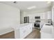 Modern kitchen featuring white cabinets, stainless steel appliances, and a center island at 13506 Copper Belly Ct, Riverview, FL 33569