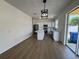 A bright kitchen with white cabinets, stainless steel appliances, and a large island is connected to the dining area at 13506 Copper Belly Ct, Riverview, FL 33569