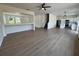 Expansive open floor plan featuring wood-look floors connecting the living spaces and kitchen at 13506 Copper Belly Ct, Riverview, FL 33569