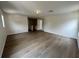 Bright, spacious living room features wood flooring and a view of the hallway and staircase at 13506 Copper Belly Ct, Riverview, FL 33569