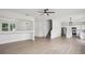 Open-concept living room featuring light wood floors and ample natural light at 13506 Copper Belly Ct, Riverview, FL 33569