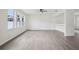 Bright living room features laminate floors, recessed lighting, built in shelves, and large windows at 13506 Copper Belly Ct, Riverview, FL 33569