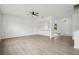 Bright and airy living room with light-colored wood floors and modern ceiling fan at 13506 Copper Belly Ct, Riverview, FL 33569