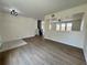 Bright and open living room with wood-look floors, neutral colors, and an airy feel at 13506 Copper Belly Ct, Riverview, FL 33569