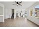 Open concept living space shows laminate floors, lots of natural light, and view of kitchen and staircase at 13506 Copper Belly Ct, Riverview, FL 33569
