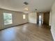 A large, naturally lit living room with wood floors and multiple windows at 13506 Copper Belly Ct, Riverview, FL 33569