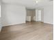 Upstairs living room features laminate floors, recessed lighting and staircase at 13506 Copper Belly Ct, Riverview, FL 33569