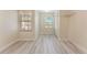 Bright bedroom with wood-look flooring, two windows, and closet with folding doors at 14506 Alejo Ct, Seminole, FL 33776