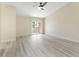 Spacious bedroom with vaulted ceilings, light wood flooring, ceiling fan, and sliding door to balcony at 14506 Alejo Ct, Seminole, FL 33776