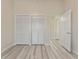 Bedroom featuring wood-look flooring and double closet doors at 14506 Alejo Ct, Seminole, FL 33776
