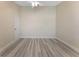 Bedroom with wood-look flooring, ceiling fan, and a white door at 14506 Alejo Ct, Seminole, FL 33776