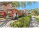Inviting entrance with lush landscaping and mature trees at 14506 Alejo Ct, Seminole, FL 33776