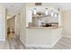 Bright kitchen featuring granite countertops, pendant lighting, and views of living area at 14506 Alejo Ct, Seminole, FL 33776