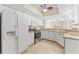 Bright kitchen with stainless appliances, white cabinets and countertops, overlooks a living area at 14506 Alejo Ct, Seminole, FL 33776