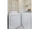 Bright laundry room with washer, dryer and wire shelving for convenient storage solutions at 14506 Alejo Ct, Seminole, FL 33776