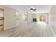 Bright living room with fireplace, ceiling fan, sliding door, and new white hardwood floors at 14506 Alejo Ct, Seminole, FL 33776