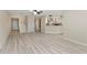 Open-concept living space with a staircase, white hardwood floors, and open kitchen at 14506 Alejo Ct, Seminole, FL 33776