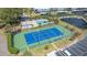 Aerial view of a community tennis court, pool, pond, parking and clubhouse at 14506 Alejo Ct, Seminole, FL 33776