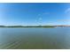 Scenic waterfront view showcasing the calm bay waters near waterfront condos under a clear blue sky at 14506 Alejo Ct, Seminole, FL 33776