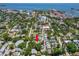 An aerial shot displays a centrally located neighborhood with a pool, marked by an arrow, and open water views at 146 8Th Ne Ave, St Petersburg, FL 33701