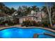 Inviting backyard oasis with a sparkling pool, relaxing spa, and comfortable lounge chairs at 146 8Th Ne Ave, St Petersburg, FL 33701