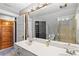 Bright bathroom featuring a double sink vanity, neutral colors, storage, and walk-in shower at 146 8Th Ne Ave, St Petersburg, FL 33701